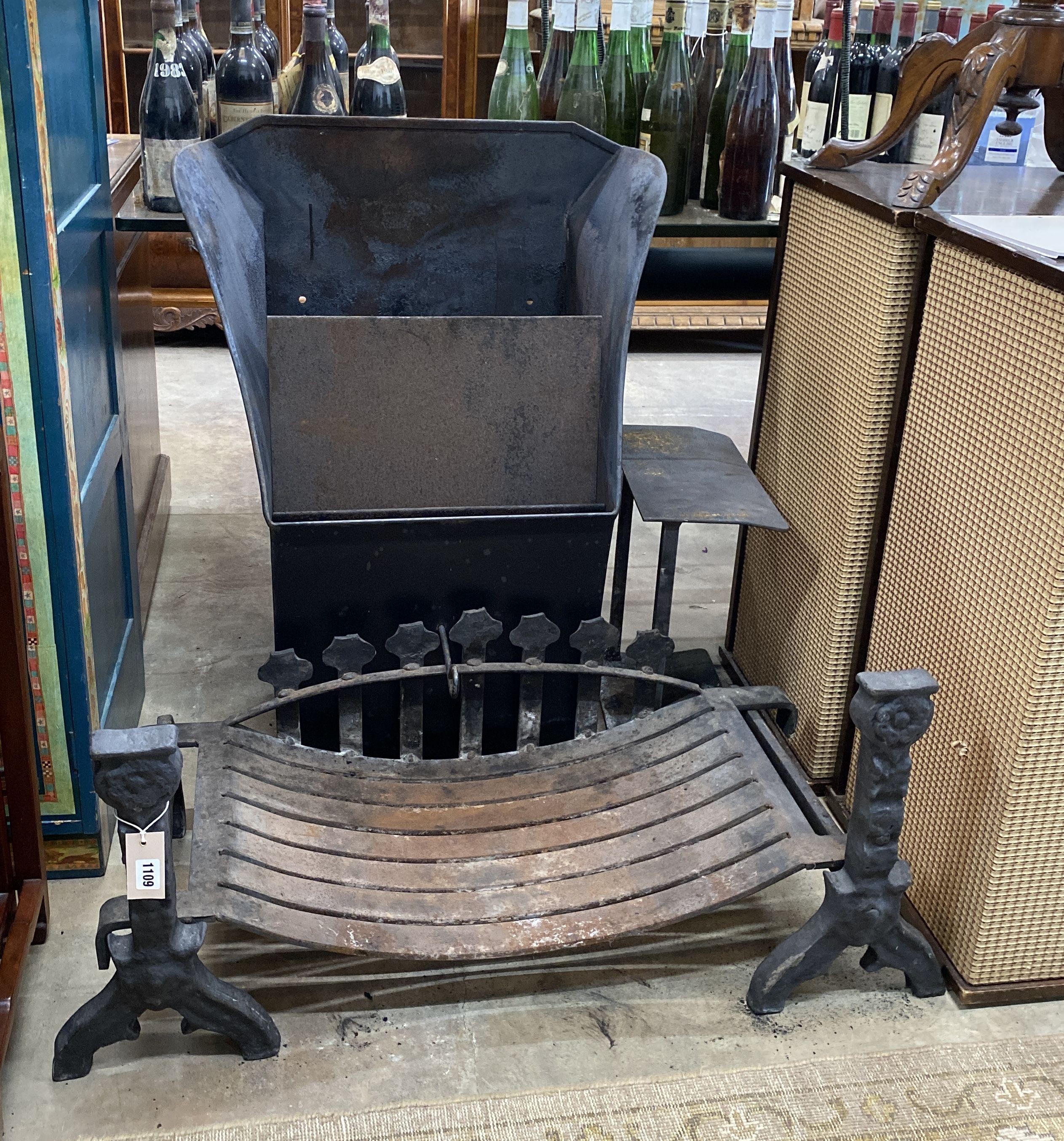 A cast iron fire basket, width 88cm, depth 37cm with dogs and a cowl
